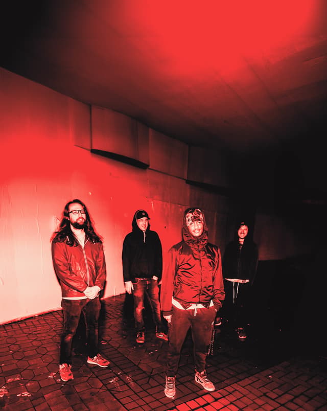 Live Alone together beneath red light outside a building at night